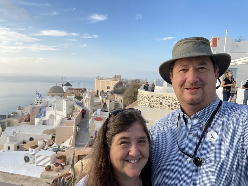Couple overlooking whitewashed buildings and sea in Santorini