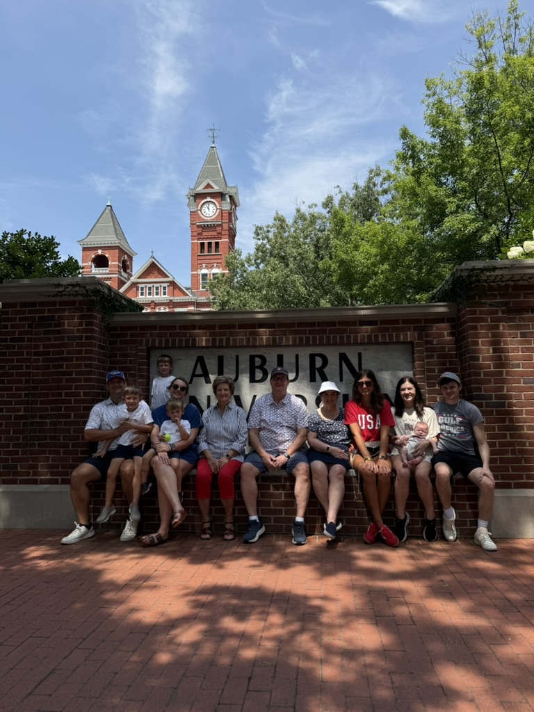 Group seated on a brick wall at Auburn University